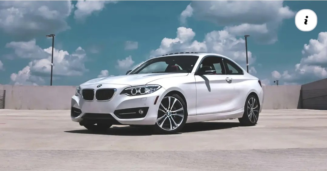 White luxury coupe on a rooftop lot
